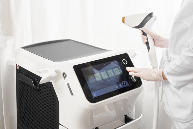 Hands of a master with modern equipment for laser hair removal and epilation in a beauty salon. Beauty salon and cosmetology