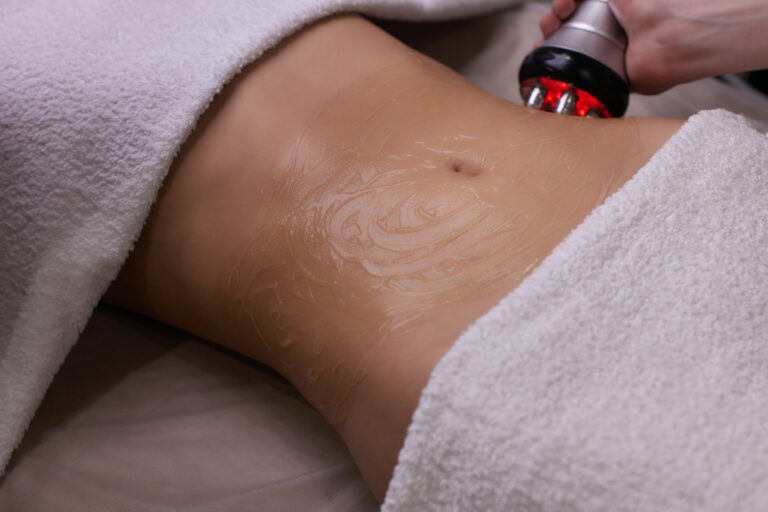 procedure removing cellulite on female abdomen, cavitation belly massage. Ultrasonic massage for weight loss. Correction of female figure without surgical intervention. Closeup of the tummy